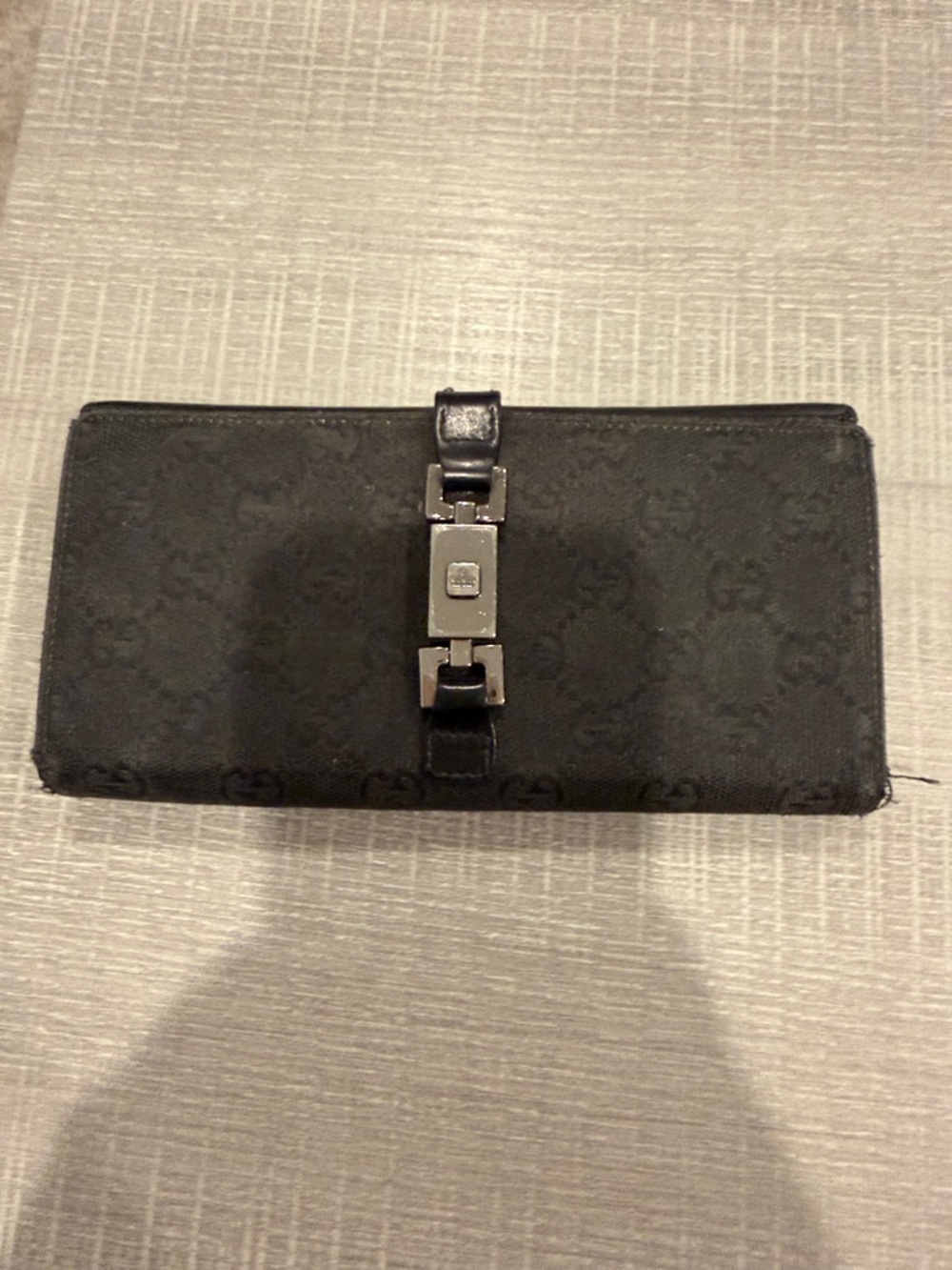 Authentic Gucci monigrammed black wallet. Silver hardware. Well loved condition.